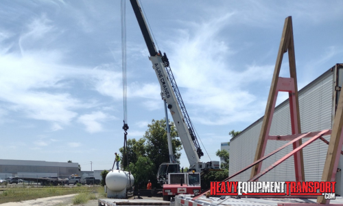 Using a crane to load an oversize tank.